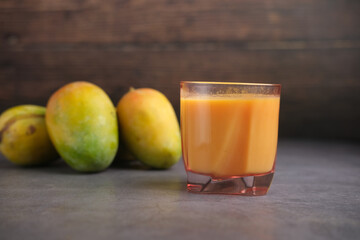 fresh mango juice with milk in a glass on table 