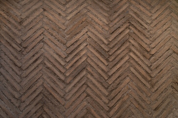 Fragment of old brick floor. Ancient red bricks in herringbone pattern. - 437887143