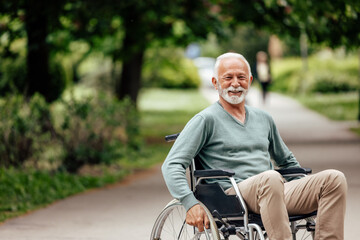 Disabled mature man, riding in his wheelchair.