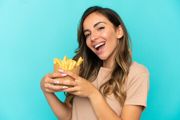 Young woman holding fried chips over isolated background