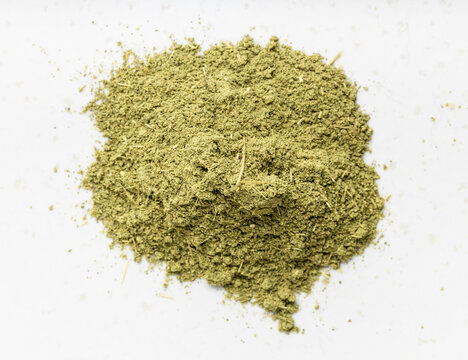 pile of milled stevia rebaudiana herb on gray