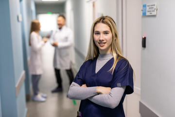 Attractive woman doctor in front of medical group