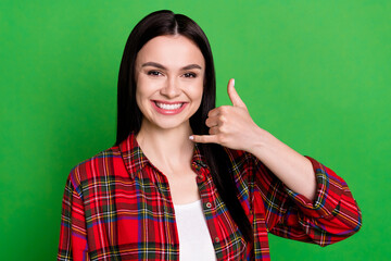 Fototapeta premium Photo of brunette cool young lady ask to call wear red shirt isolated on green color background