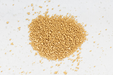 pile of granulated dried yeast close up on gray