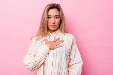 Young australian woman isolated taking an oath, putting hand on chest.