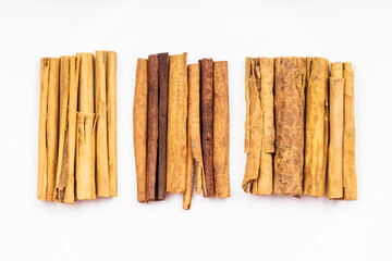 top view of various cinnamon sticks on white plate