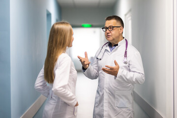 Healthcare doctors having discussion in hospital corridor