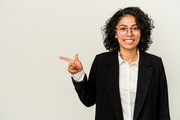 Young latin business woman isolated on white background smiling and pointing aside, showing something at blank space.