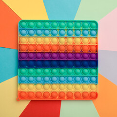 Close up colorful silicone children toy antistress pop it top view on colorful background 