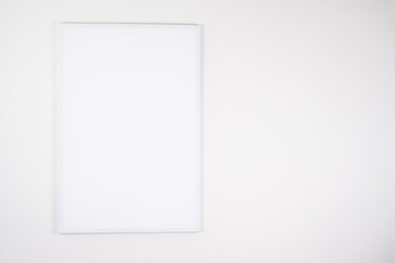 Real white picture frame on a white wall background, fine details and large canvas for creative freedom