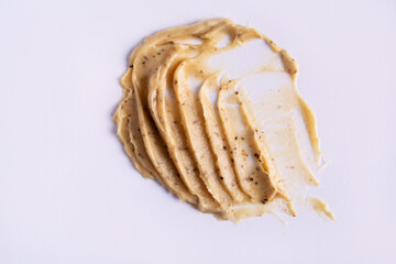 Skin scrub smear on white background. Cosmetic product. Cleansing and exfoliating your skin