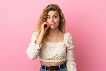 Young blonde woman isolated on pink background showing a sign of silence gesture