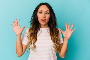 Young mexican woman isolated on blue background screaming to the sky, looking up, frustrated.