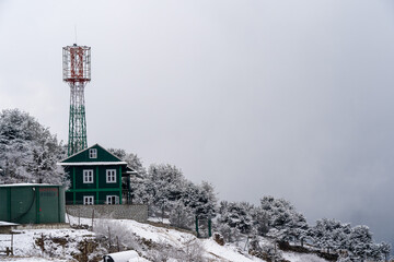 Snow Covered Hillside and Radio Tower