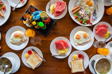 American breakfast and salad with fruit and juice on wooden table. Easy morning eating concept. Image on top view.