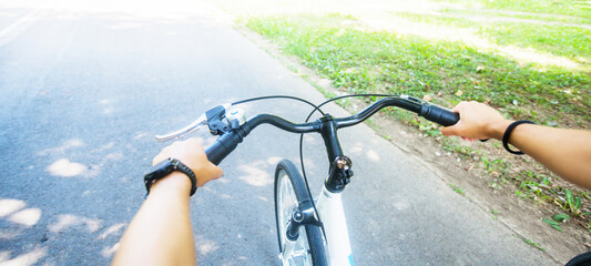 Female biker hands, view of bike cyclist