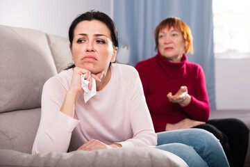 Portrait upset adult women looking away after conflict at home interior