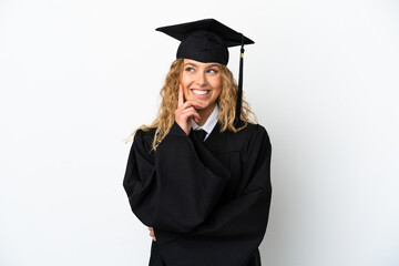 Young university graduate isolated on white background thinking an idea while looking up