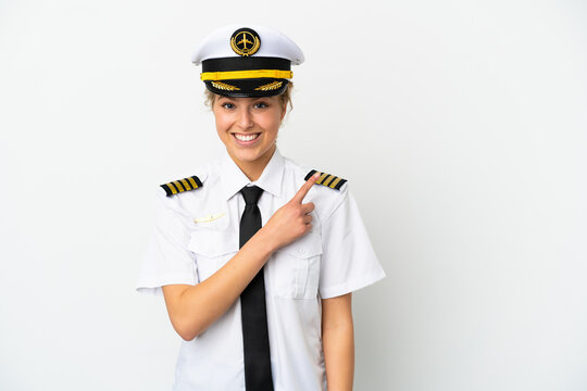 Airplane blonde woman pilot isolated on white background pointing to the side to present a product