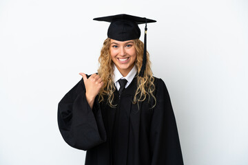 Young university graduate isolated on white background pointing to the side to present a product