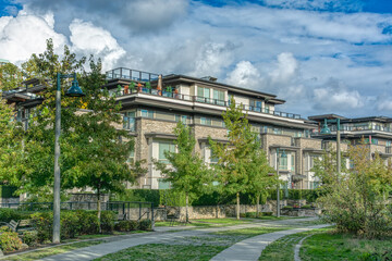 Residential apartment building on cloudy sky background