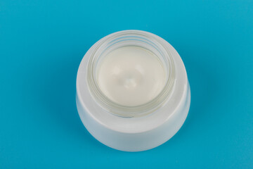 Beauty Cream Texture Close Up. Cosmetic skincare product in jar on blue background. High Quality