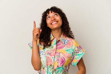 Young mixed race woman isolated on white background indicates with both fore fingers up showing a...