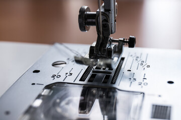 Production line sewing machine. Needle and footstep detail