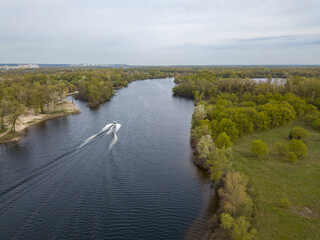 Fototapeta na wymiar Motor boat with water skis on the river. Aerial drone view.