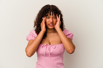 Young mixed race woman isolated on white background having a head ache, touching front of the face.