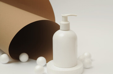 Light cosmetic bottles with lilac on background.
