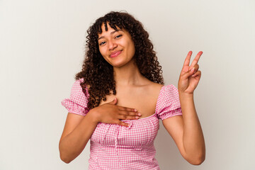 Young mixed race woman isolated on white background taking an oath, putting hand on chest.