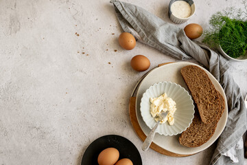 Obraz na płótnie Canvas Ingredients for healthy farm cooking - eggs, whole wheat black bread, goat cream cheese and fresh raw fennel