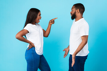 Black couple arguing, angry woman screaming at annoyed man