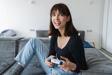 Happy young white woman holding joystick © Drobot Dean