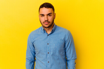 Fototapeta premium Young caucasian man isolated on yellow background sad, serious face, feeling miserable and displeased.