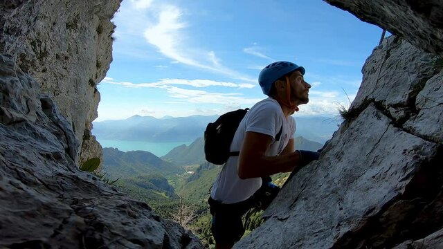Climber Ascending Corna delle Capre Via Ferrata Above Lake Iseo, Monte Guglielmo, Italy