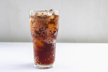 .Glass of soft drinks and black soft drinks on the table