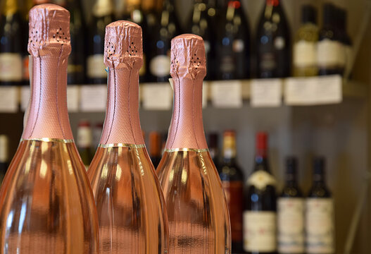 Rose, sparkling wine bottles in wine store and ready for home delivery