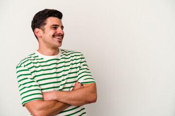 Young caucasian man isolated on white background smiling confident with crossed arms.