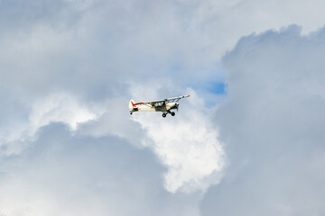 Fototapeta na wymiar Motor aircraft flying among the clouds in the sky