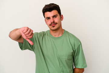 Young caucasian man isolated on white background showing a dislike gesture, thumbs down. Disagreement concept.