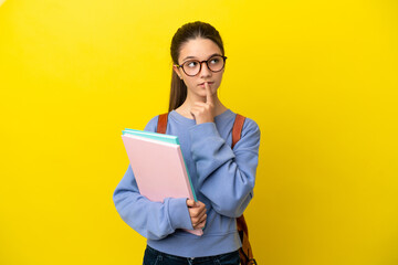 Fototapeta premium Student kid woman over isolated yellow background having doubts while looking up