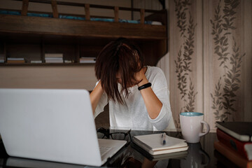 Upset asian woman working from home office.