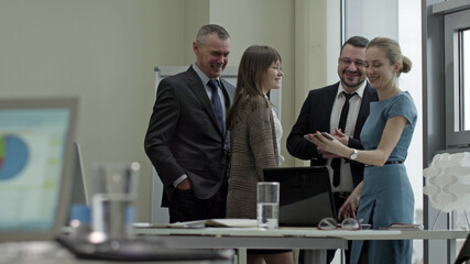 Smiling business team working with smartphones in office