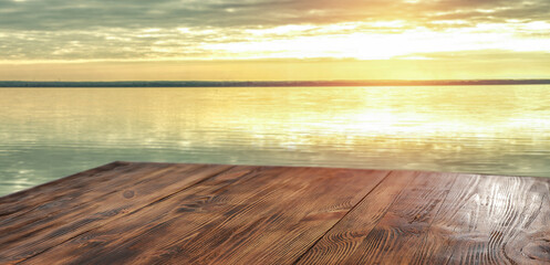 A wooden table on a beautiful sunny holiday day with a charming sea landscape 