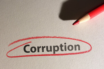 Corruption text circled in red pencil on texured paper