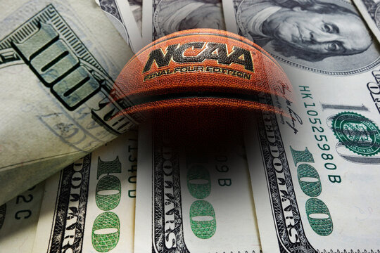 Wilmington,NC - USA - 05-07-2021: Composite image of an NCAA Final Four Edition basketball and money