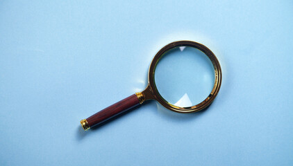 Magnifying glass on the blue background.