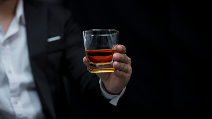 Closeup businessmen holding a glass of whiskey